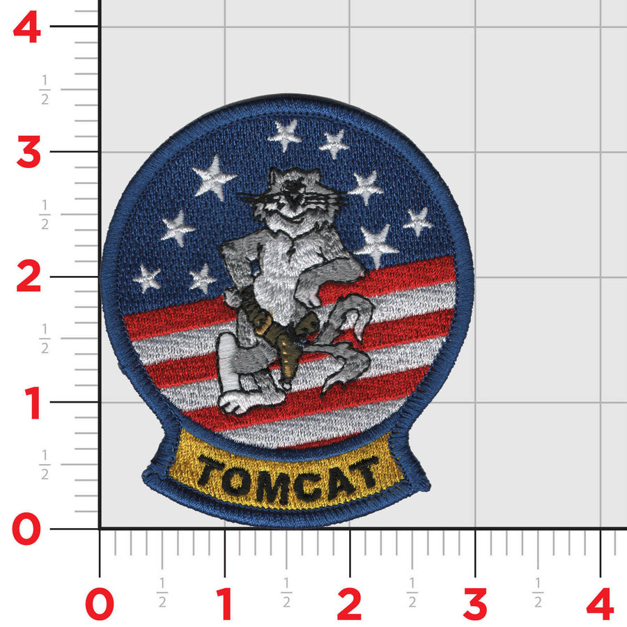 An embroidered patch featuring an illustration of an F-14 Tomcat aircraft with a pilot figure, surrounded by stars and the name 'TOMCAT' at the bottom.